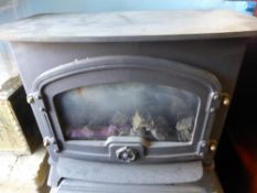 A Cast Iron Wood Burner fitted for gas.