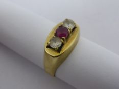 A lady`s 14 ct. 585 hallmark yellow gold ring set with a ruby and two diamonds, approx. 3.2 gms.