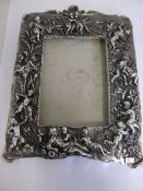 A silver metal photograph frame depicting cherubs.