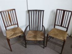 Three Edwardian Rush Seated Chairs - all with turned legs and stretchers, the one being a low