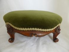 A Mahogany Footstool on Scroll Feet and covered in green velvet.