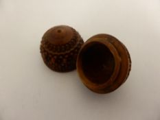 A two section nutmeg grater in the form of a coquilla nut ( lacking grater)