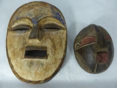 Two Congolese hand painted face masks, one oval Bwami blue and white face mask, 24 cms together with