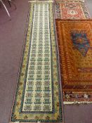 Three Middle Eastern style carpets including two hall runners and one other. (i) 298 x 99 cms, (