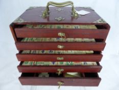 A box game of Mah Jong, the interior with five fitted drawers for tablets, together with a biscuit