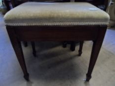 A Victorian Mahogany Piano Stool having a beige velvet lift up seat on tapered legs and spade