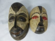 Two Carved Wooden West African `Galoa` Face Masks, hand painted, both oval in shape 23 cms and 29