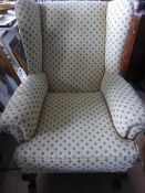 Cream Upholstered Wing Back Chair.
