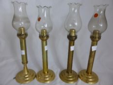 Four Indian Brass and Gemini Glass Lamps, labelled Andhra Kurnool.