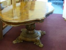An Edwardian Scallop Edged Dining Table being walnut effect on a heavy bulbous base with carved