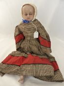 An Antique Wax Doll with various hand made clothes, the doll having wax head with articulated