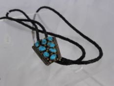 An American Navaho Indian braided leather necktie with silver and turquoise neckpiece with silver