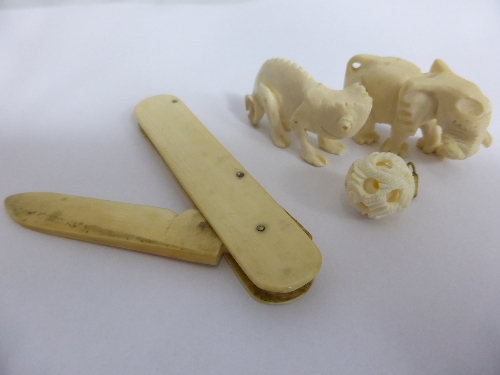 Collection of misc Ivory including a pen knife, carved elephant pendant, miniature puzzle ball