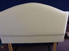 An upholstered headboard being of cream cotton with green high lights approx. 138 cms. wide