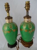 Two porcelain lamp bases in emerald green with white and gilt decoration with two gilt shades