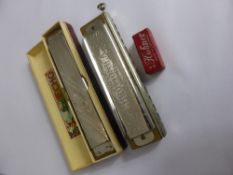 An M Hohner Harmonica `The Echo` in original case, a Hohner Chromonica 270 and a miniature harmonica