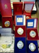 A collection of Halcyon Days Enamels including two scented candles, five Christmas enamel boxes, a
