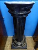 An ebonised plinth in the form of a corinthian column, approx. 120 cms. tall.