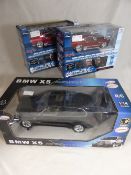 Three radio controlled model cars comprising a Rastar 1/14 BMW X 5 and two 1/24 Ford Mustangs, all