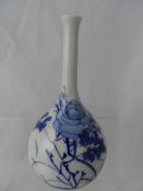 A Chinese blue and white slim necked vase hand painted with flowers, approx. 16 cms.