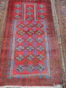 A Antique Middle Eastern Wool Prayer Rug, the rug having a burgundy background with bright blue