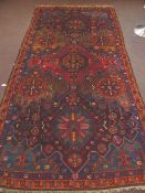 Middle Eastern Wool Carpet, with bold colours, hues of red, orange, pink turquoise, intricate