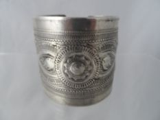 Antique solid silver oriental bangle depicting fish within a geometric design, maker`s marks to