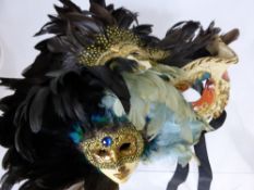 Two Venetian Paper Mache Masks together with a feathered Porcelain mask and three miniature masks