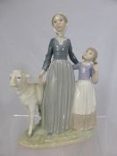 A Porcelain LLadro Figure of a young farmer`s wife with her daughter and a ram, 23 cms high.