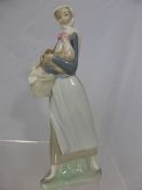 A Porcelain Lladro figure of a young woman and a cockerel, 26 cms high.