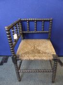 Antique rattan seated small corner chair having bobbin decoration to the back, spindles, legs and