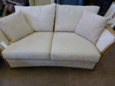 A cane Tonga double sofa with cream upholstery approx. 175 x 97 cms.