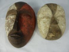 Two Carved Wooden West African `Galoa` Face Masks, hand painted, the first circular 20 cms and the