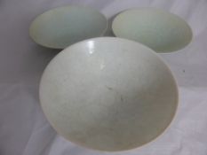 Three Chinese celadon bowls having cloud and flower design, approx. 21 cms. diameter