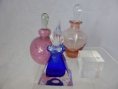 A Collection of Three Perfume Bottles with a commemorative Millenium Dome together with four glass