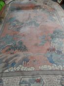A Large Washed Chinese Carpet, the carpet having a predominantly pink background depicting a