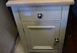 A pair of Neptune bedside cabinets having single cupboards and single drawers, the tops being