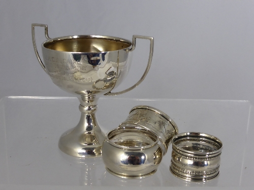 A Solid Silver Trophy and three silver napkin rings, approx. 110 gms.