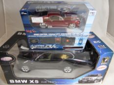 Two radio controlled model cars comprising a Rastar 1/14 BMW X 5 and a Maisto 1/24 Ford Mustang