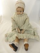 An Antique Wax Doll having a wax head and articulated cloth limbs, approx. 84 cms. long.