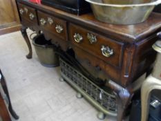 A Reproduction Oak Sideboard in the Georgian style having three drawers being on hoof feet, the