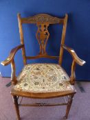 An Edwardian Oak Bedroom Armchair on turned legs and stretchers with a lyre back and a floral