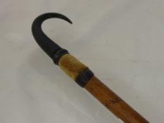 An Antique Shepherd`s Crook having a goat hoof and horn handle, the cane having the wording "