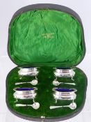 A Set of Four Solid Silver Salts, Sheffield hallmark, with the original blue glass liners,