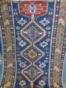 An Antique Caucasian Rug, the rug having five central ghouls with tribal motif to inner frieze,