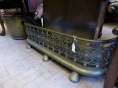 An Edwardian brass fender having a pierced gallery with floral motif together with two Edwardian