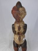 West African Tribal Forest Guardian, the carved wooden figure depicts a man, hand painted with ochre