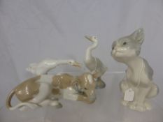 Four Lladro Porcelain figures depicting a sitting cat, two geese and a calf.