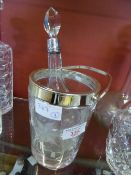 Silver Plated Miniature Ice Bucket together with a silver collared cut glass bottle.