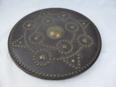 Leather and Brass Replica Battle Shield, circular with studded decoration.